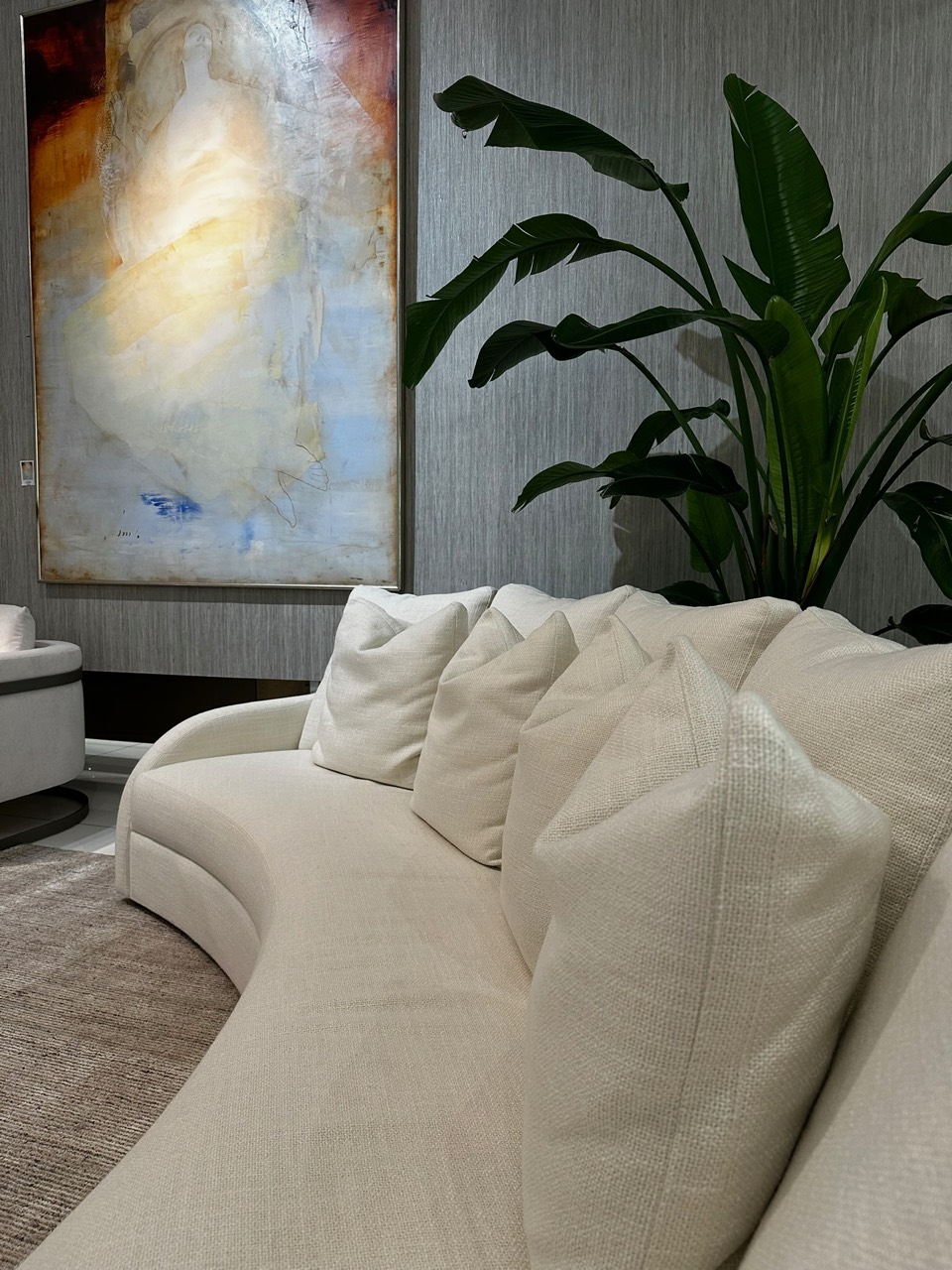 Living space with sculptural seating, artwork, and planting